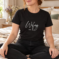 Wifey Script Est. Year Iron-On Transfer, shown on a black t-shirt