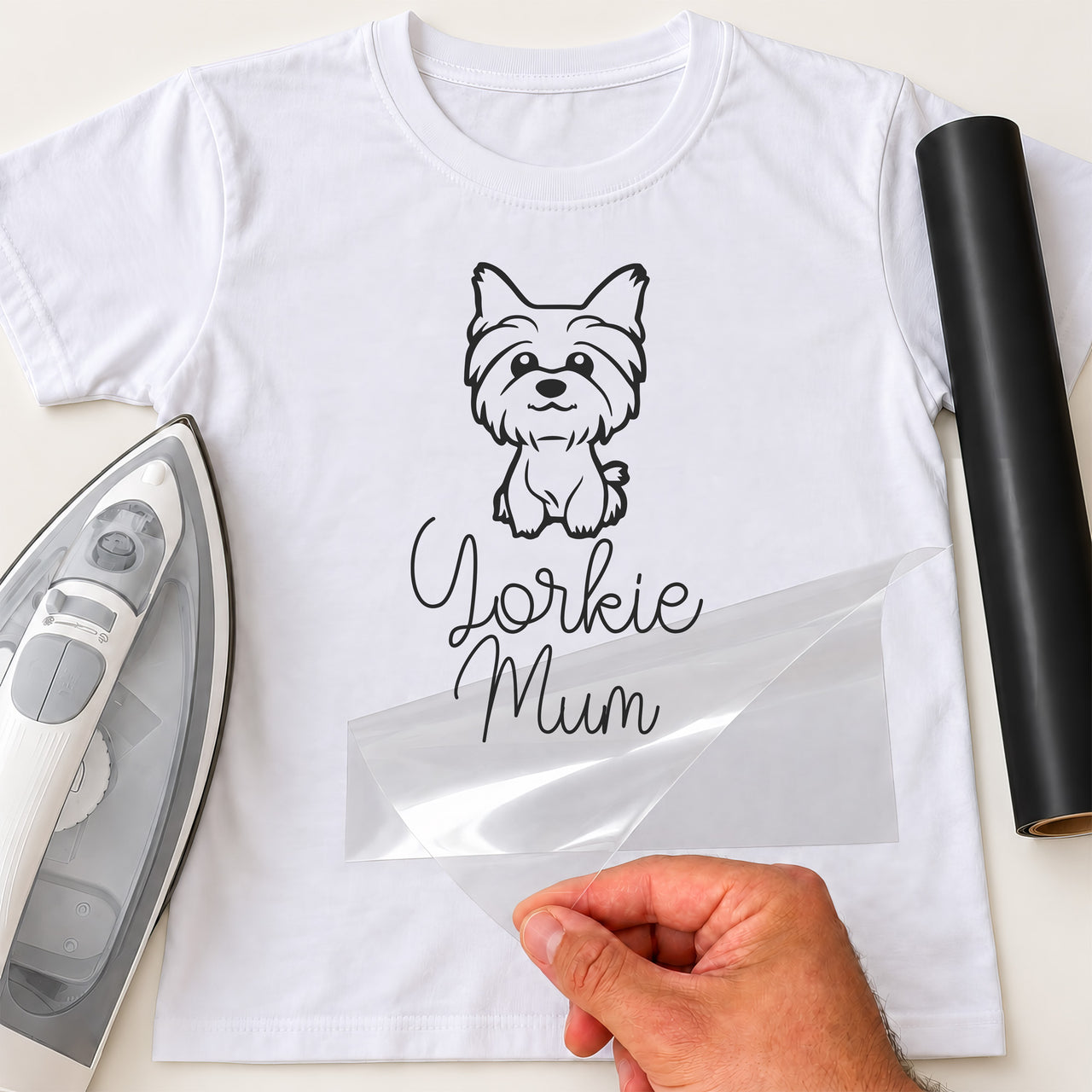 White T-shirt with black line drawing of a small dog and script 'Yorkie Mum', film peeled off - iron-on vinyl transfer