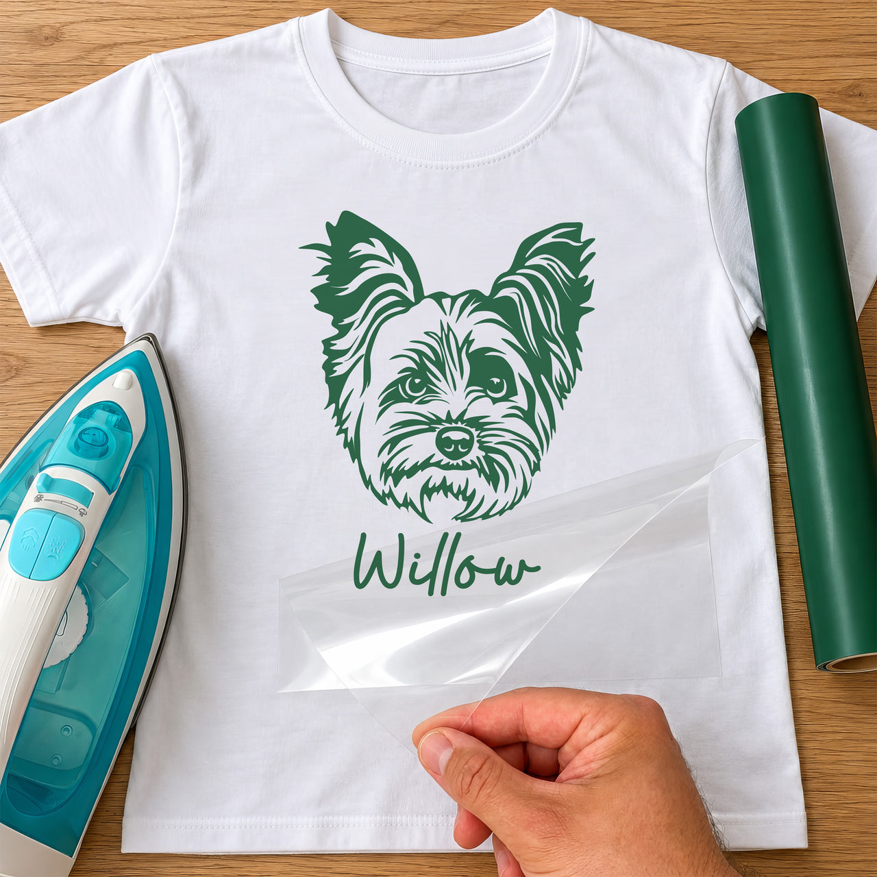 Yorkshire Terrier iron-on transfer: green Yorkshire Terrier face with the name Willow on a white T-shirt, film being peeled