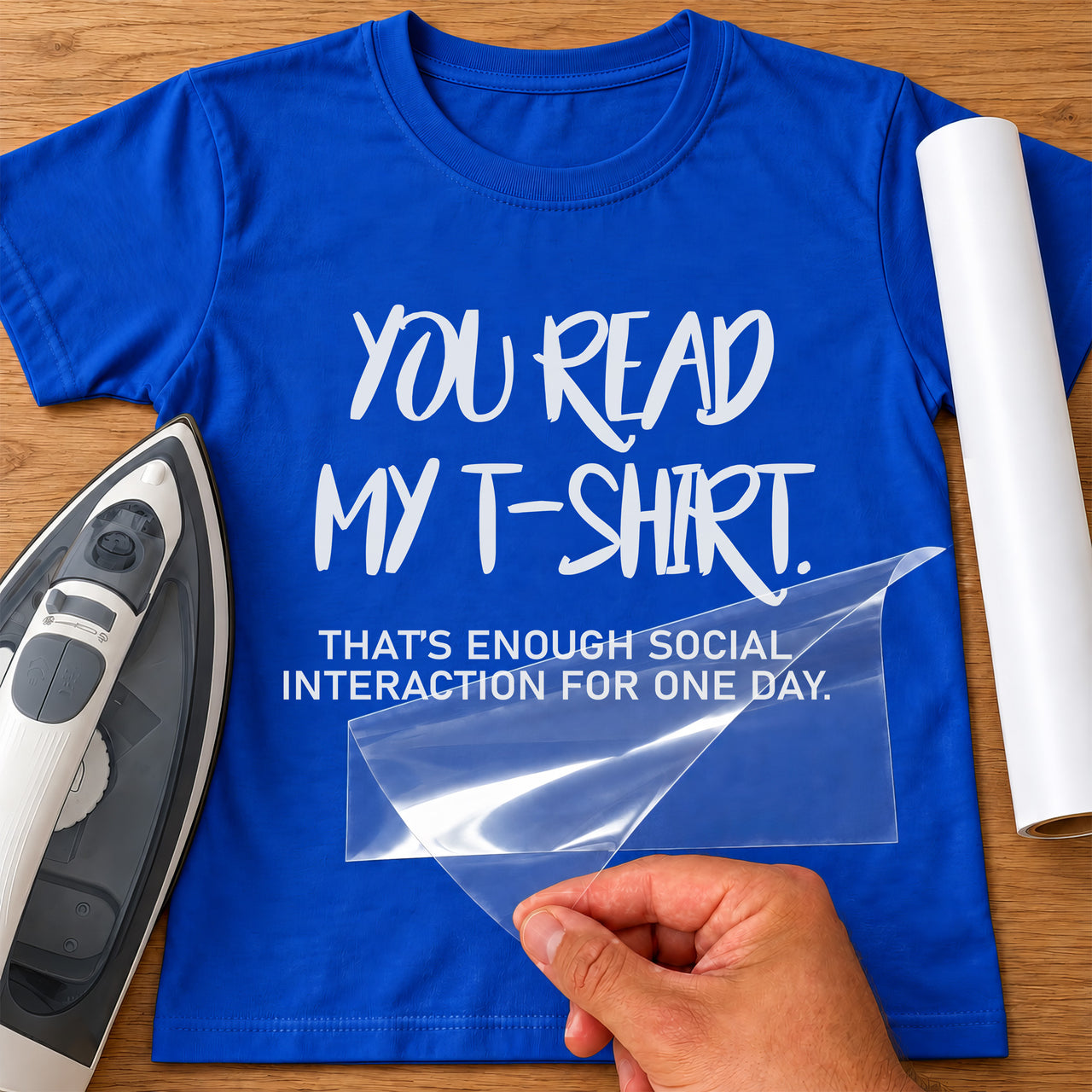 Slogan iron-on transfer: white YOU READ MY T-SHIRT. THAT'S ENOUGH SOCIAL INTERACTION FOR ONE DAY. on a blue T-shirt