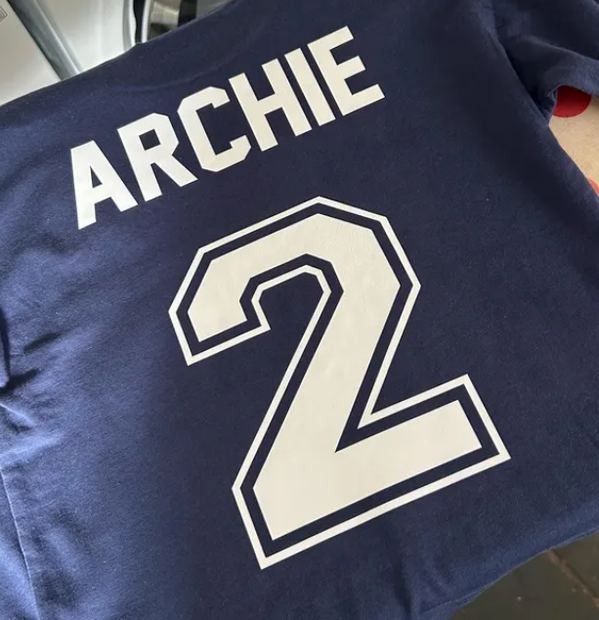 Buyer photo: ARCHIE and number 2 in white matte vinyl on a navy T-shirt