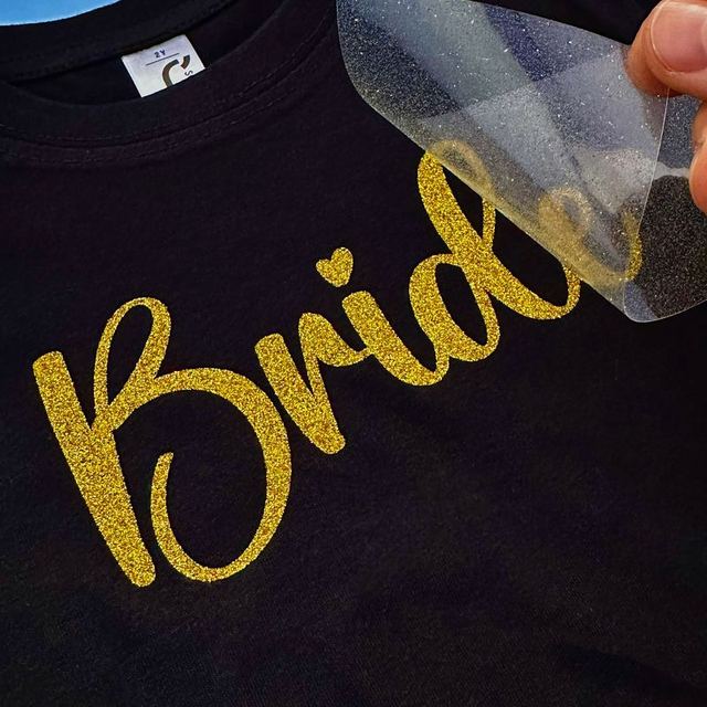 Gold glitter Bride lettering, clear carrier being peeled