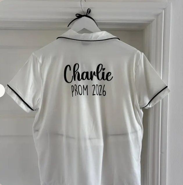 White pyjama top with Charlie, PROM 2026 in black vinyl on the back, buyer's photo